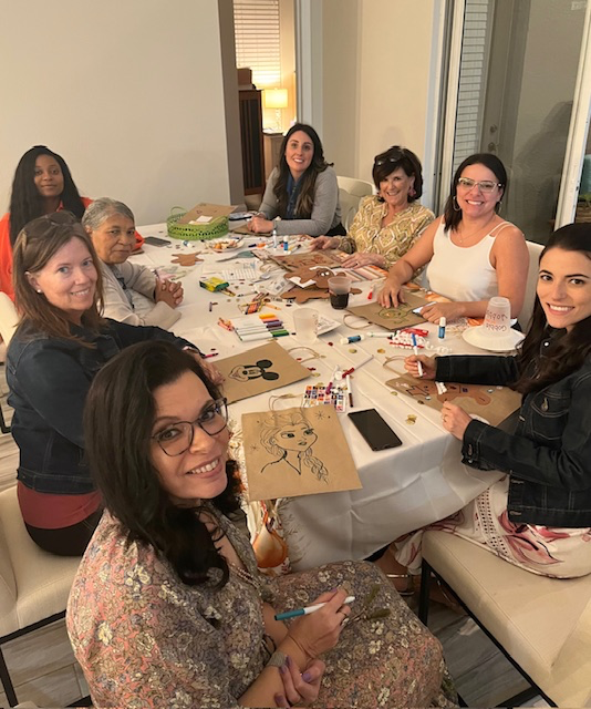 Florida Lawyers Mutual President & CEO Cathleen M. Sargent joins community members in decorating holiday bags for charitable organization HOPE Help's annual holiday drive.